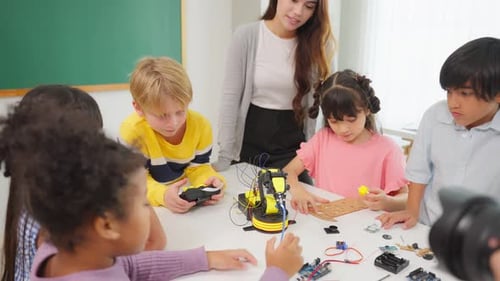 Group of student learning together in classroom at elementary school.