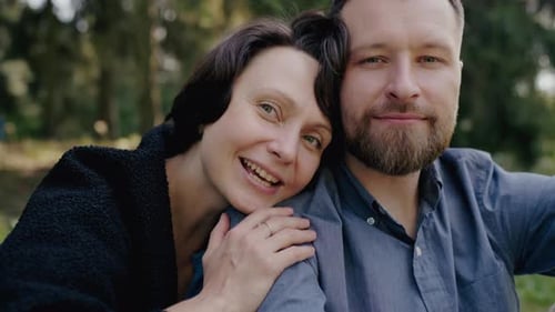 Happy Couple Embracing in a Sunny Park Setting Love and Joy