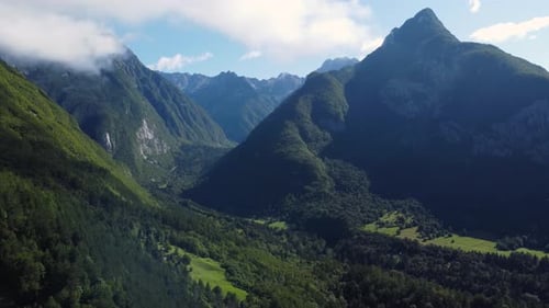 AERIAL Orbiting Shot of a Dramatic Green Mountainous Landscape in the Alps