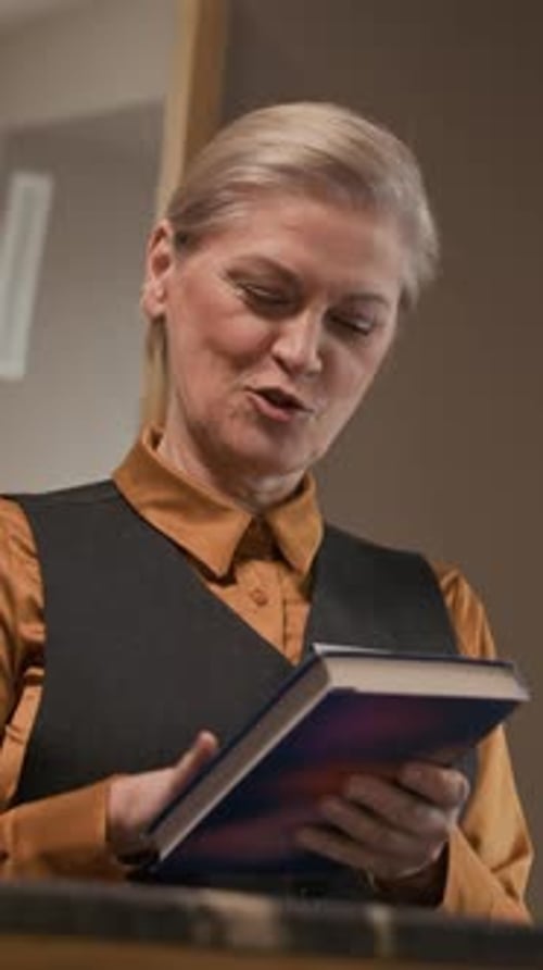 Vertical of Bookstore Employee Processing Payment at Checkout Counter