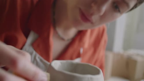 Potter Smoothing Clay on Pottery Wheel, Close Up