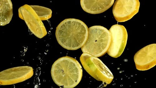 Lemon Slices Flying on a Black Background Filmed on a Highspeed Camera at 1000 Fps
