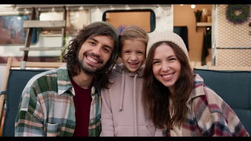 Portrait of a Happy Family a Brunette Guy with Stubble in a Green Plaid Shirt a Brunette Woman in a