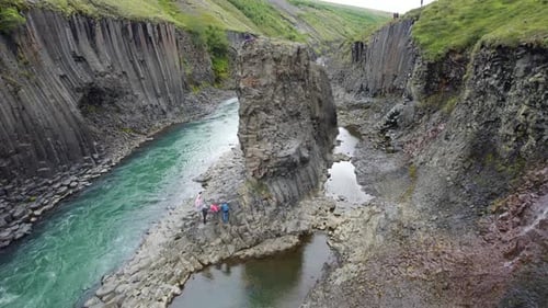 Aerial Of Hikers Exploring Stuðlagil Ravine. Dolly Forward