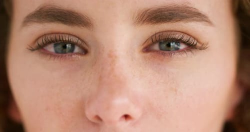 Closeup face of a young emotional woman with tears in her eyes