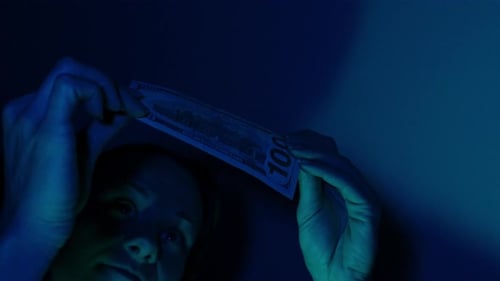 Counting Money in Blue Light