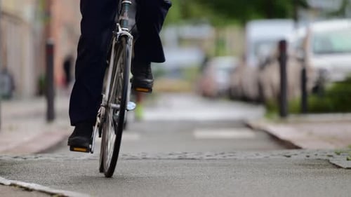 Cyclists riding on a street bike lane in slow motion. . Copenhagen, Denmark