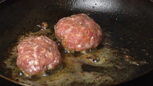 Meat patties or cutlets in form of cutlets, fried in oil in pan,