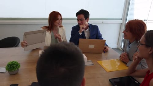 Group of architects having a meeting in a luminous office, working together around an architectural