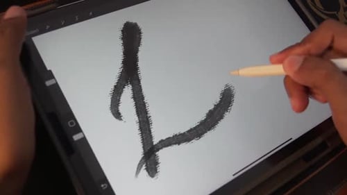 Artist Drawing Love with Stylus on Digital Tablet
