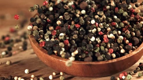 A Plate with Peppercorn Falls on the Table Filmed on a Highspeed Camera at 1000 Fps