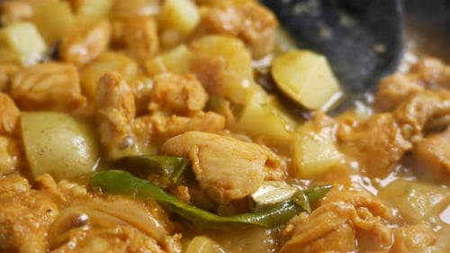 Chicken Cooking with Potatoes and Green Peppers