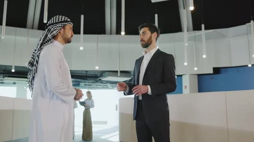 Business Discussion Between Two Men in Modern Office