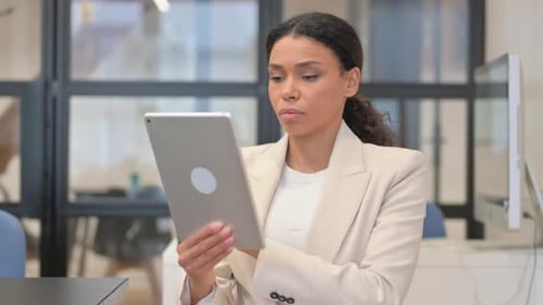 Woman in Blazer Using Tablet in Office