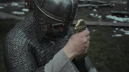 Medieval Soldier in Chainmail Helmet, with Sword Praying before Leaving for War