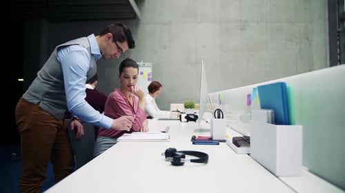 Group of Young Businesspeople Working Together in Office, Talking