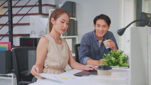 Asian young businessman and businesswoman people working in office.