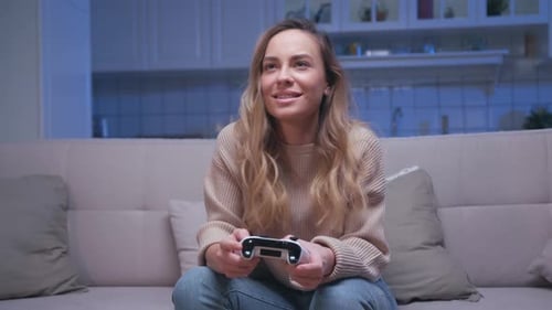 Woman Smiling, Playing Video Game on Couch