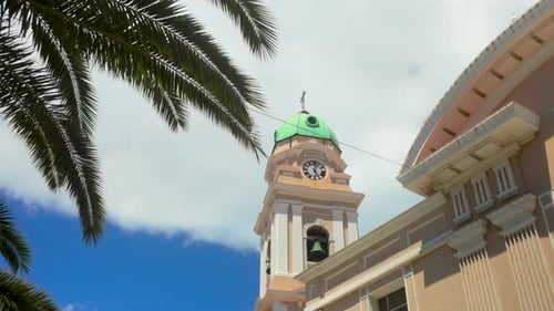 The clock tower of a historic building in Gibraltar - Cathedral of St Mary the Crowned, framed by pa