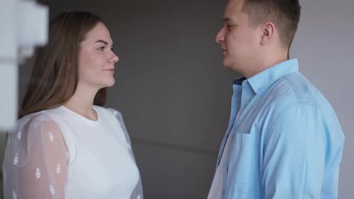 Side View Positive Happy Couple Talking Gesturing Highfive Standing in New Flat