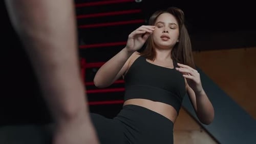 Athletic Woman in Selfdefense Stance Preparing to Block in Martial Arts Training at Fitness Center