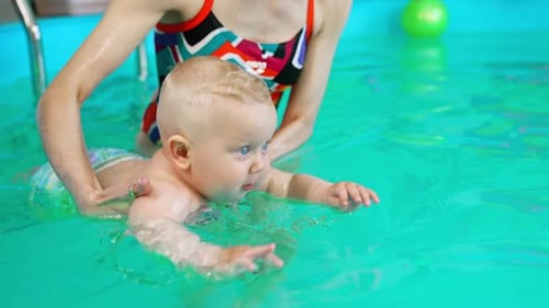Baby Swimming with Adult Guidance in Indoor Pool