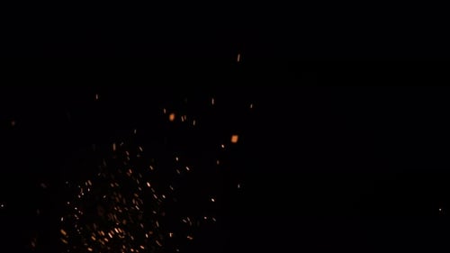 Abstract Gold Sparks Rising on Black Background