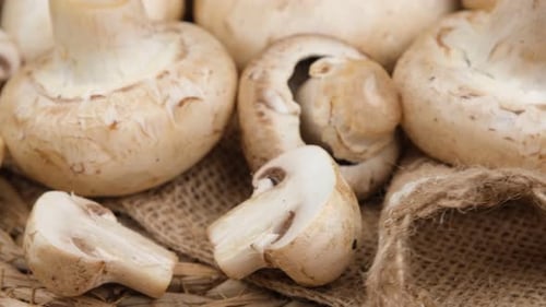 Fresh White Mushrooms Close Up on Burlap