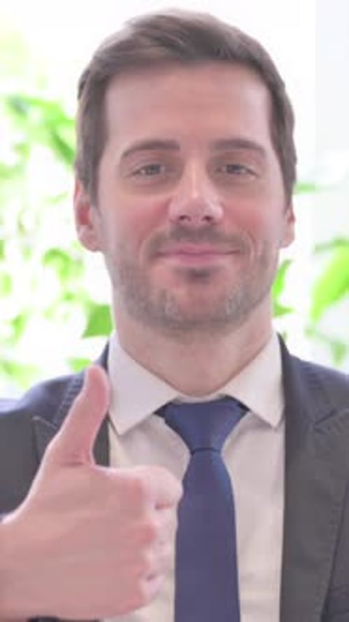 Thumbs Up By Excited Young Businessman in Office, vertical video