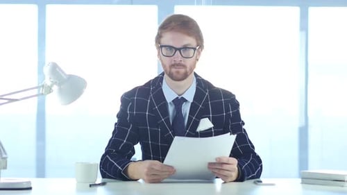 Redhead Businessman Giving Documents Paperwork in Office