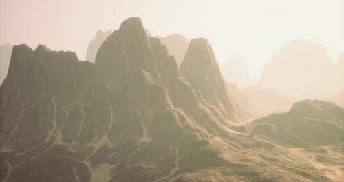 Majestic Misty Mountains Rise Under the Gentle Sunlight in a Tranquil Landscape