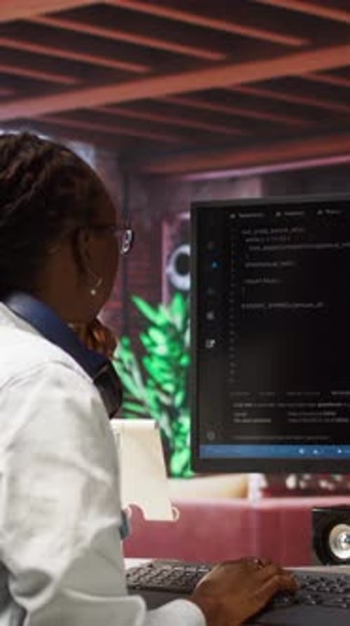 Adult Typing Code at Desk in Office