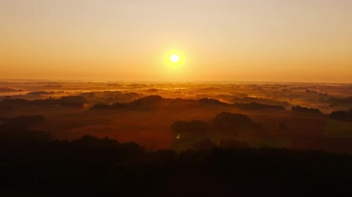 Golden Sunrise Over Misty Rolling Hills and Foggy Valley Landscape