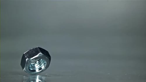 The Nut is Spinning on a Metal Table Filmed on a Highspeed Camera at 1000 Fps
