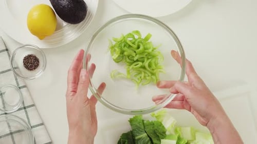 Preparing Fresh Salad with Vegetables and Lemon