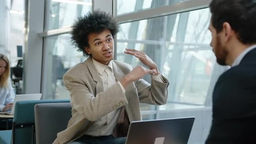 Young Adults Discussing Business in Modern Workplace