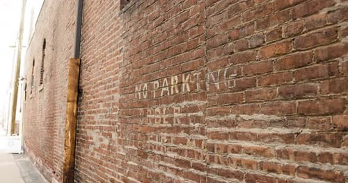 Brick Wall with Painted No Parking Sign Closeup from Right
