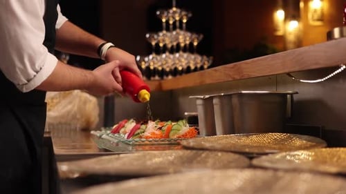 Chef prepares seafood dishes in a Japanese restaurant