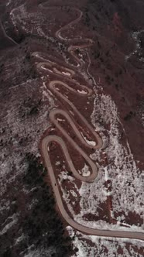 Vertical Aerial Fly Over Zigzag Road Through Arid Mount Zao Volcanic Landscape, Japan