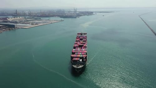 Cargo Ship Moving to Sea from City Port