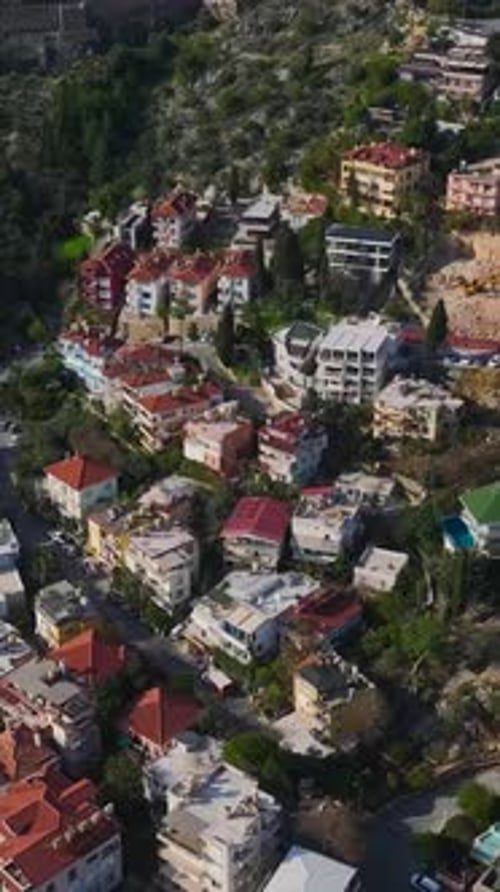 Vertical Video of an Ancient Fortress Overlooking the Sea Captured From Above Surrounded By Green