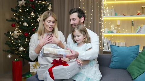 Happy Family Exchanges Gifts on Christmas Morning
