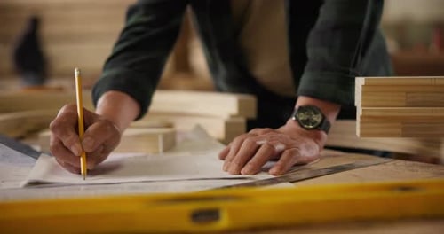 Hands, man and drawing on blueprint on table with pencil for planning a building design