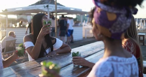 Happy Girls Toasting Mojitos at Beach Party