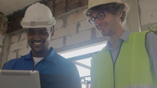 Teamarchitekt zwei junger Mann diskutieren und suchen digitales Tablet für Inspektionsbaustelle.