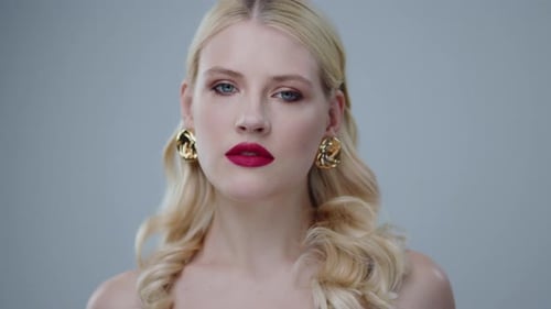 Woman Portrait with Blonde Hair and Gold Earrings