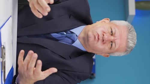 Stressed Man Rubbing Temples at Desk