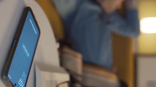 Smartphone with Blue Screen and Man in Background