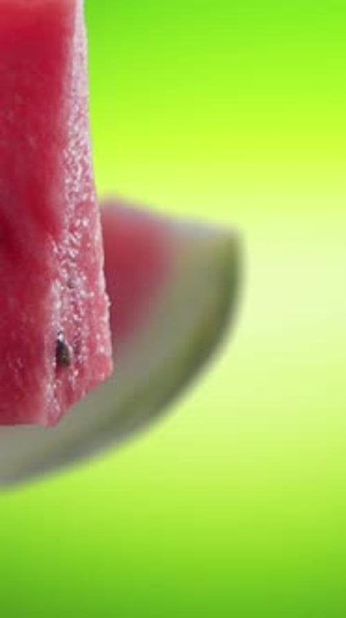 Flying of Watermelon and Slices in Green Background
