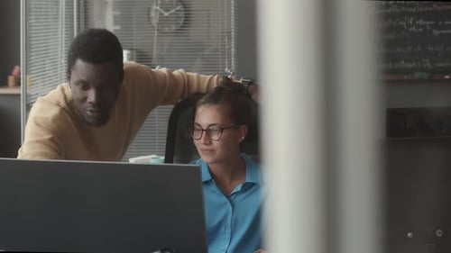 Two Colleagues Having DIscussion in IT Company Office